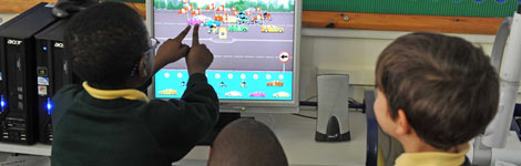 Boys looking at a computer at school