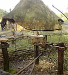 Image of a reconstructed Iron Age house and pole lathe