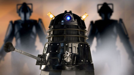 Photograph of a Dalek with Cybermen in the background © BBC/Adrian Rogers