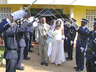 Senior police officers form an avenue of crossed swords for one of their colleague's wedding celebrations.