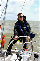 Man at wheel of ship