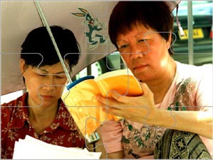 Jigsaw puzzle. Two Hong Kong women reading