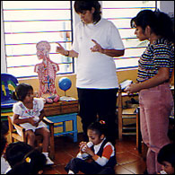 conducting street kids playing 'recycled' instruments in Mexico