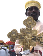 Ethiopian Coptic man carrying large golden crucifix