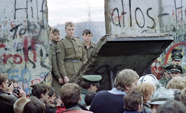East German soldiers look through a gap in the Berlin Wall. (Photo: AFP/Getty Images)