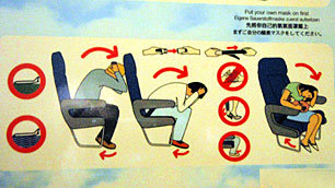 Close-up view of the airline safety card on Liz's flight, detailing how to adopt the brace position