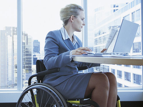 Businesswoman in wheelchair with laptop