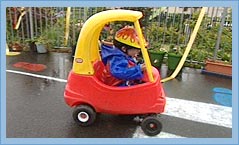 Photo of a child in a toy car