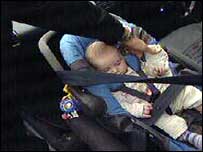 Car seat being checked for correct fitting