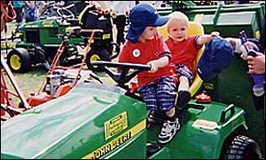 Picture: Two young boys play on a tractor.
