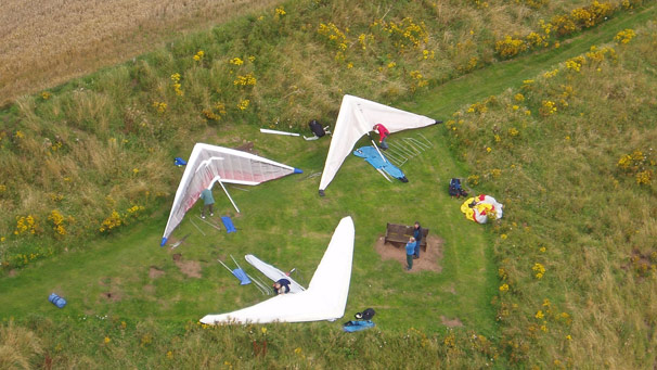 Aerial shot of hang-gliders on ground