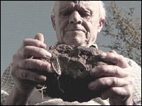 Farmer Dudley Coombe holding a stone