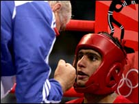 a boxer getting some support from the coach 'in his corner'