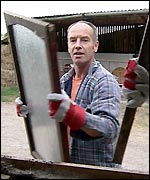 Man carrying a window frame