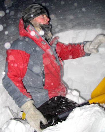 Mountaineer beginning to dig snow-hole
