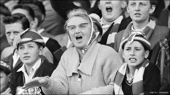 Supporters watch a football match in 1962