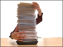 A woman with a pile of documents