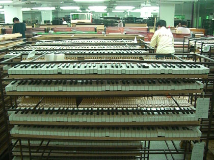 keyboards piled up a the Pearl River Piano factory