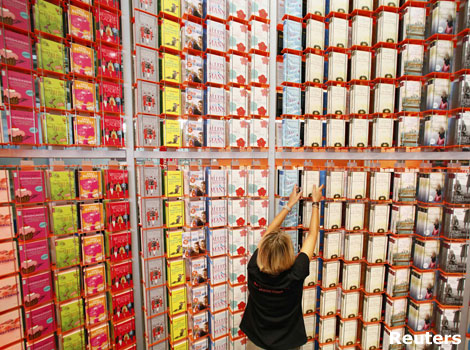 A woman sorting books at a book fair.