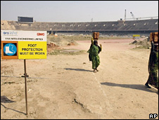 Workers at a Commonwealth Games site in Delhi