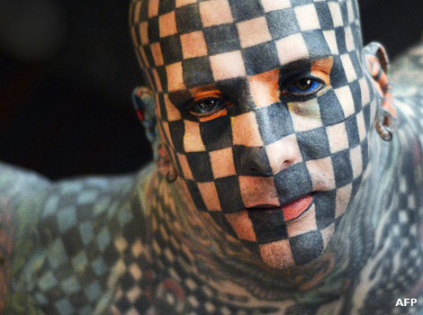 A heavily tattooed man