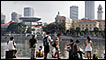 People sit by the Singapore River 