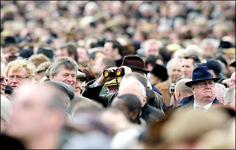 Spectator looks through binoculars at the Cheltenham National Hunt Festival 2008 (Getty image)
