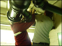 Plumbers fixing a leak