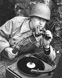 Robin Duff, BBC War correspondent assigned to the US Air Force, using a Midget recorder 
