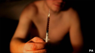 Man holding syringe with heroin