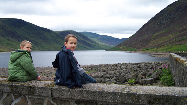 Two boys sitting on a wall beside Loch Turret, Perthshire