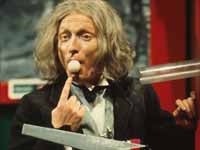 Man with ping-pong ball in mouth.