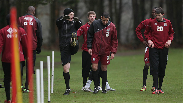 Glen Thurgood (centre) takes the Northampton squad through some strength and conditioning exercises.