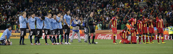 Uruguay players, left, and Ghana players, right, line up during penalty shootouts