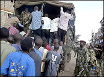 mungiki suspects are rouded into a truck by Kenyan police
