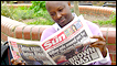 The BBC's Joseph Warungu reading the Sun newspaper