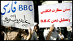 Protestors in Iran hold up placards stating (l-r) "BBC Persian is against the government of the people" and "Close down the British Embassy and close down the BBC"