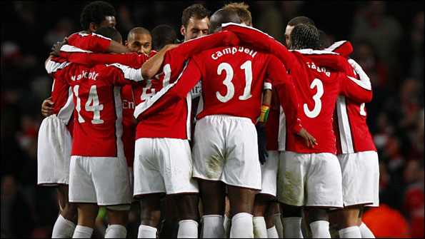 Arsenal's players gather in a huddle after the game