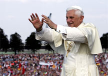 Pope Benedict XVI in front of crowds of young Catholics with hands held out in blessing