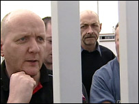 men behind a gate