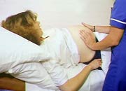 Pregnant woman being examined by a nurse
