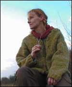 Agnes Kiemel watches her dogs at work in the field