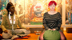 Seaneen straddles some cushions for meditation