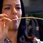 Liz Bonnin bending a spaghetti strand