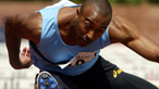 Colin Jackson jumping over a hurdle