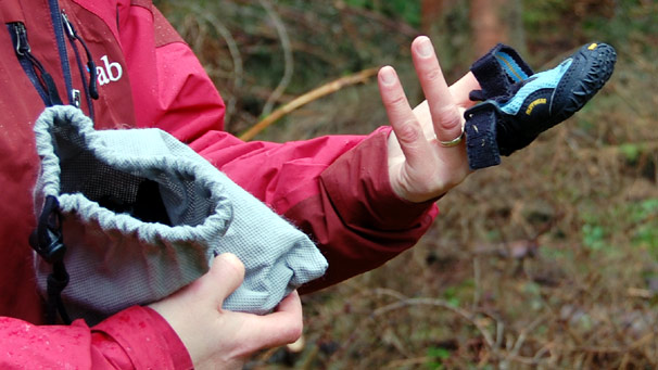 Handler demonstrates dog's paw shoes