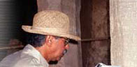 Image of Professor Fekri Hassan examining ancient stone hieroglyphics