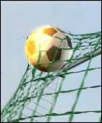 Football going through the net.