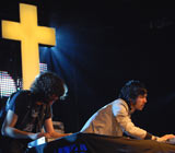 Justice performing live at Radio 1's Big Weekend 2008 with an enormous cross as a backdrop