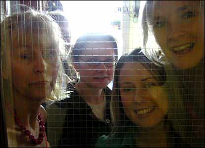 Outlook team members looking through the glass of the door to room 805